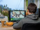 male gamer playing strategy game on computer with snacks lying on table - stock photomale gamer playing strategy game on computer with snacks lying on table - stock photomale gamer playing strategy game on computer with snacks lying on table - stock photo